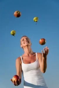 Woman Juggling Fruit